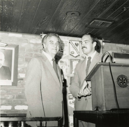 Unidentified Men Stand Behind Rotary International Podium