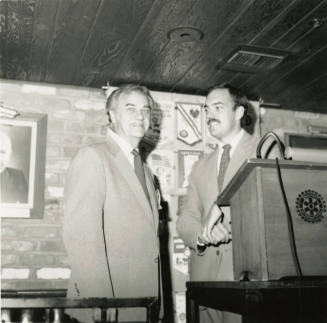 Unidentified Men Stand Behind Rotary International Podium