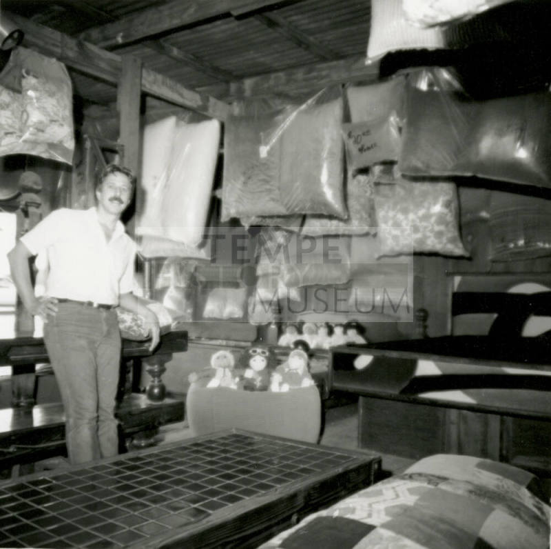 Man with stuffed animals and bagged material