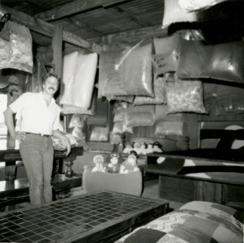 Man with stuffed animals and bagged material