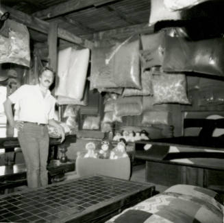 Man with stuffed animals and bagged material