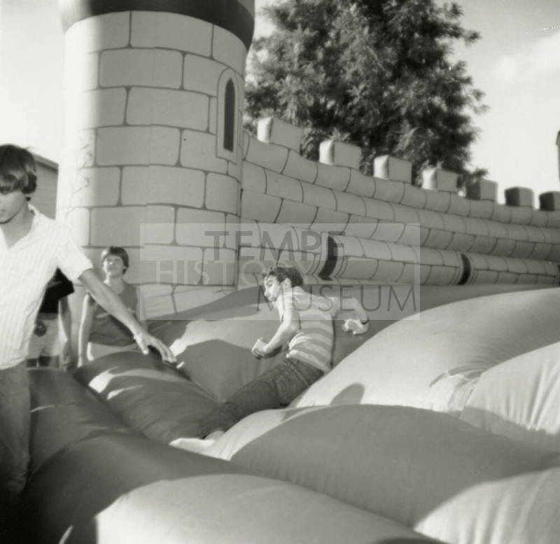 Unidentified children on inflated mock castle