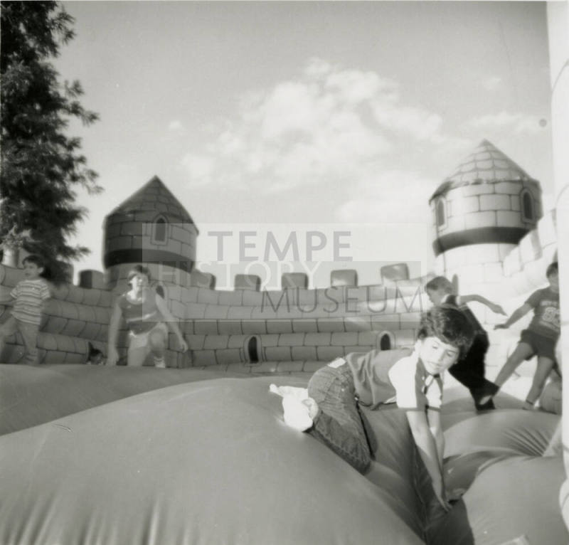 Unidentified children on inflated mock castle