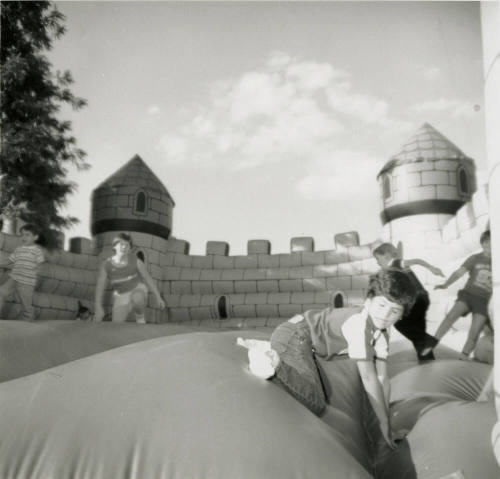 Unidentified children on inflated mock castle
