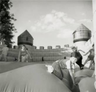 Unidentified children on inflated mock castle