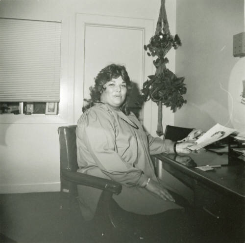 Unidentified woman sitting at an office desk