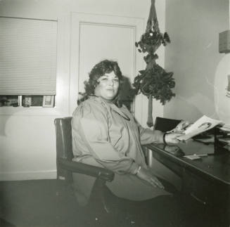 Unidentified woman sitting at an office desk