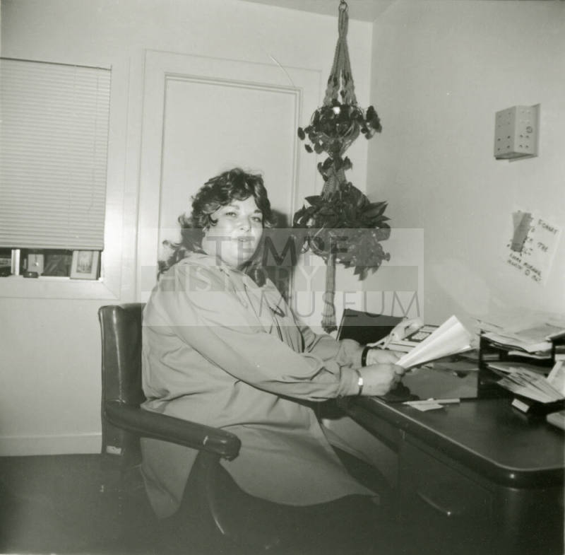 Unidentified woman sitting at an office desk