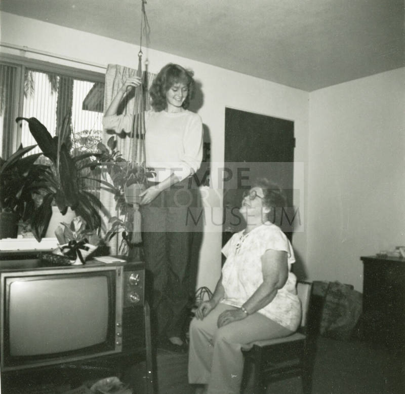 Unidentified standing lady and an unidentified sitting lady