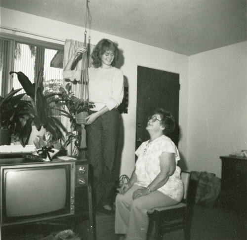 Unidentified standing lady and an unidentified sitting lady