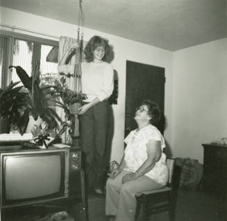 Unidentified standing lady and an unidentified sitting lady