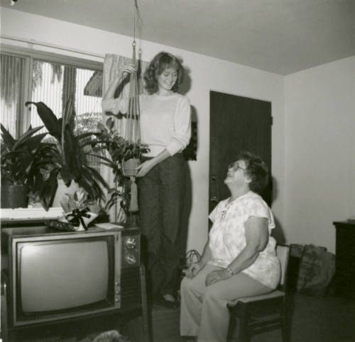 Unidentified standing lady and unidentified sitting lady
