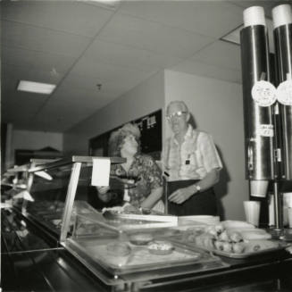Unidentified Couple Behind A Cafeteria Line