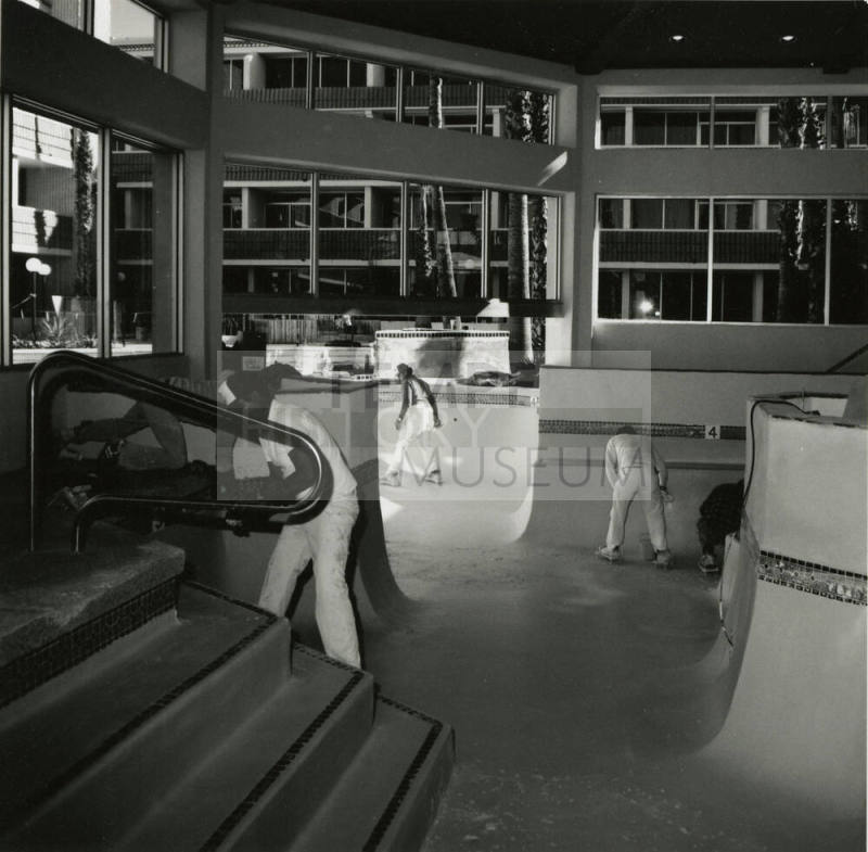 Interior view of workmen cleaning pool area of New Ramada Hotel Airport East