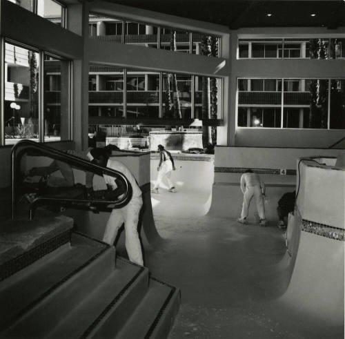 Interior view of workmen cleaning pool area of New Ramada Hotel Airport East