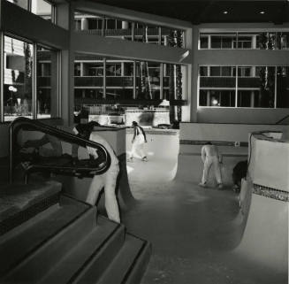 Interior view of workmen cleaning pool area of New Ramada Hotel Airport East