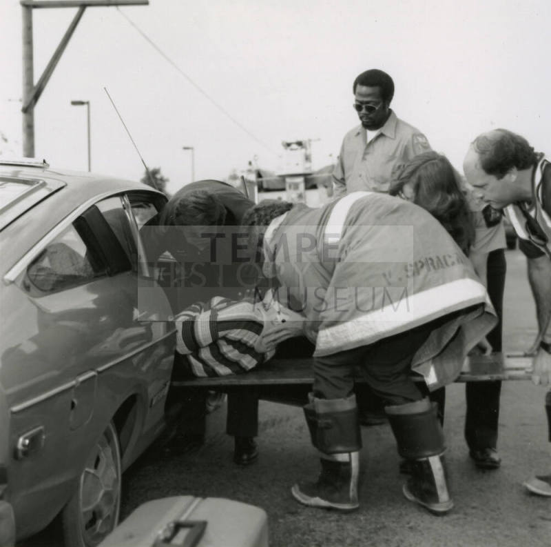 Paramedics Removing Woman from Vehicle After Car Collision