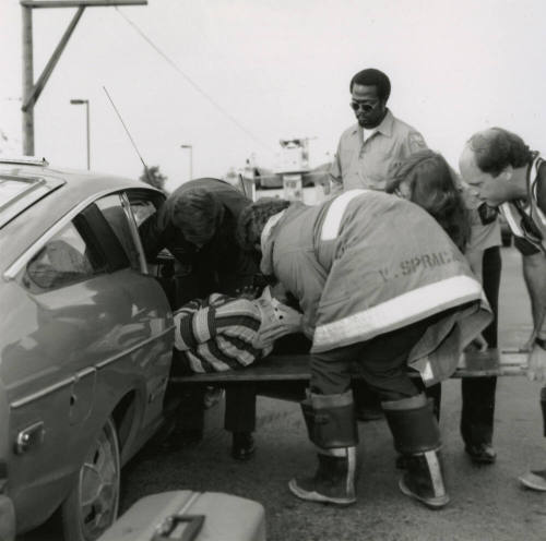 Paramedics Removing Woman from Vehicle After Car Collision