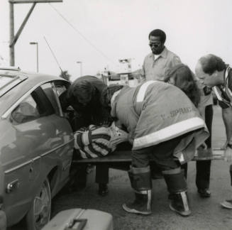 Paramedics Removing Woman from Vehicle After Car Collision