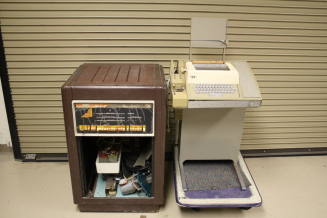 PDP-8L computer with teletype. paper readers, paper tapes, logic cards and cabinet