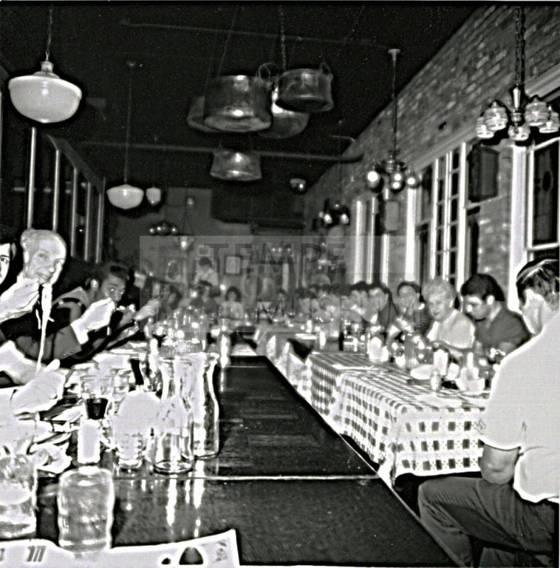 Unknown group of people dining in a large room
