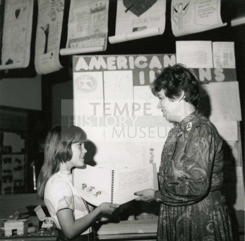 Unidentified young girl with unidentified adult