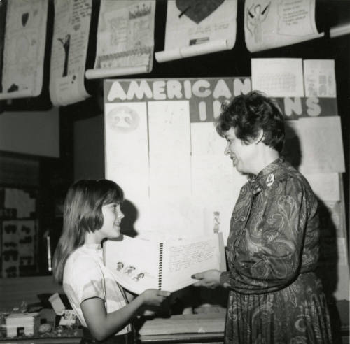 Unidentified young girl with unidentified adult