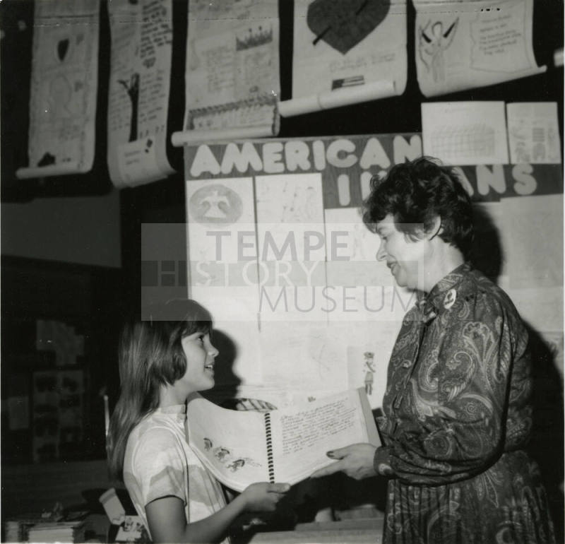 Unidentified young girl with unidentified adult