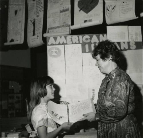 Unidentified young girl with unidentified adult