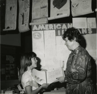 Unidentified young girl with unidentified adult