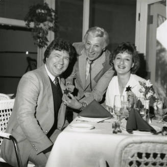 Young woman and two men, one being given a sheriff's badge