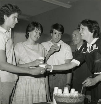 Unidentified Group Gathered Around A Punch Bowl