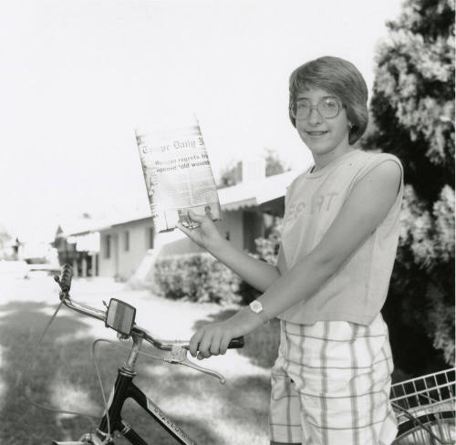 Carrier hangs up her paper bag, from Tempe Daily News, May 11, 1985