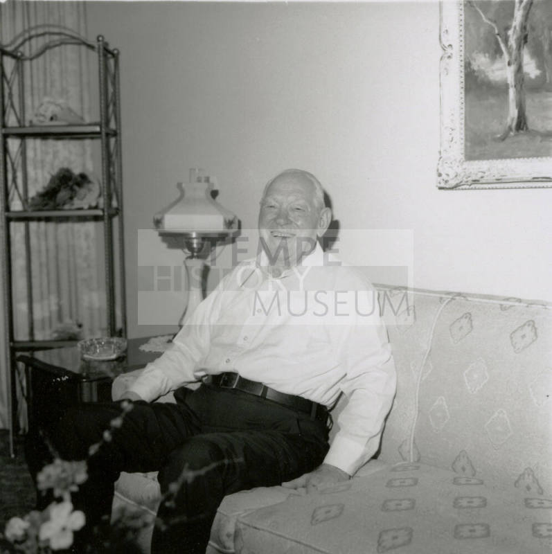Unidentified happy and smiling man on sofa
