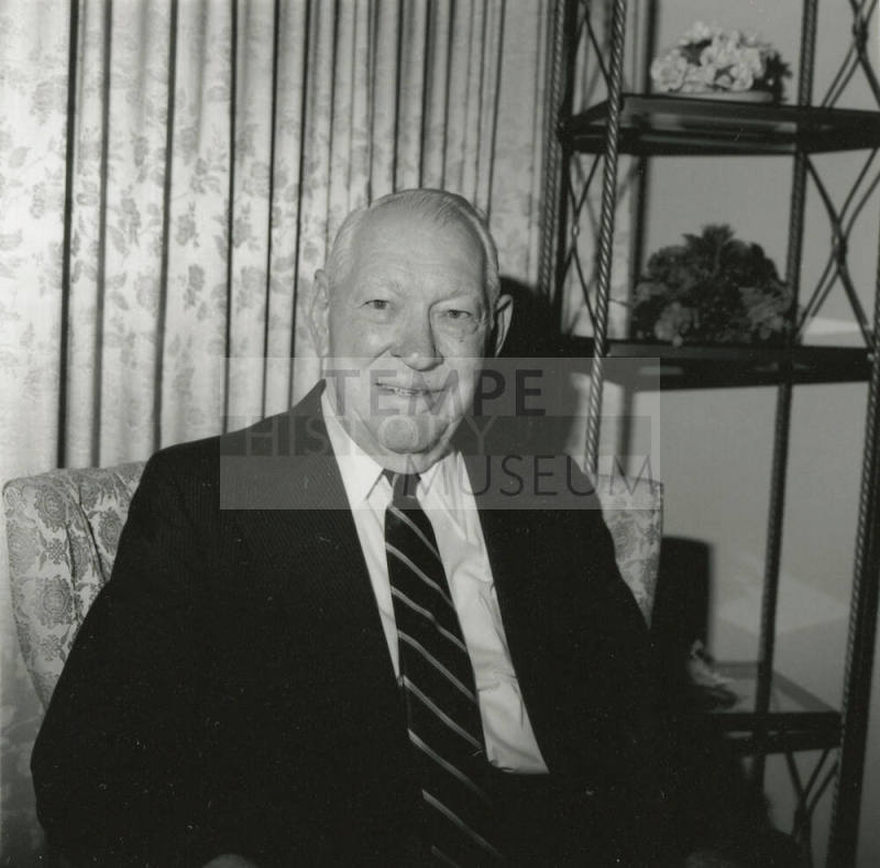 Unidentified Smiling Man Sits & Smiles in Living Room - (1 of 2)