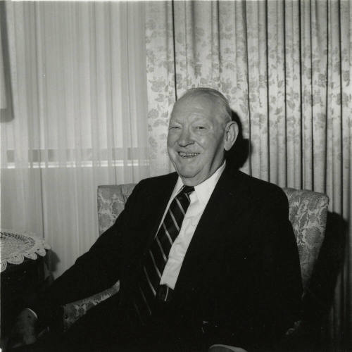 Unidentified Smiling Man Sits & Smiles in Living Room - (2 of 2)