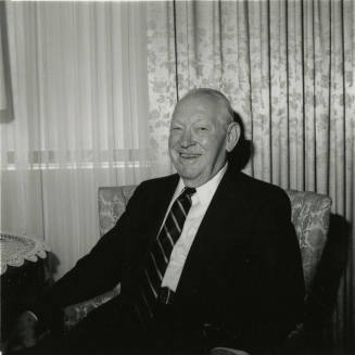 Unidentified Smiling Man Sits & Smiles in Living Room - (2 of 2)
