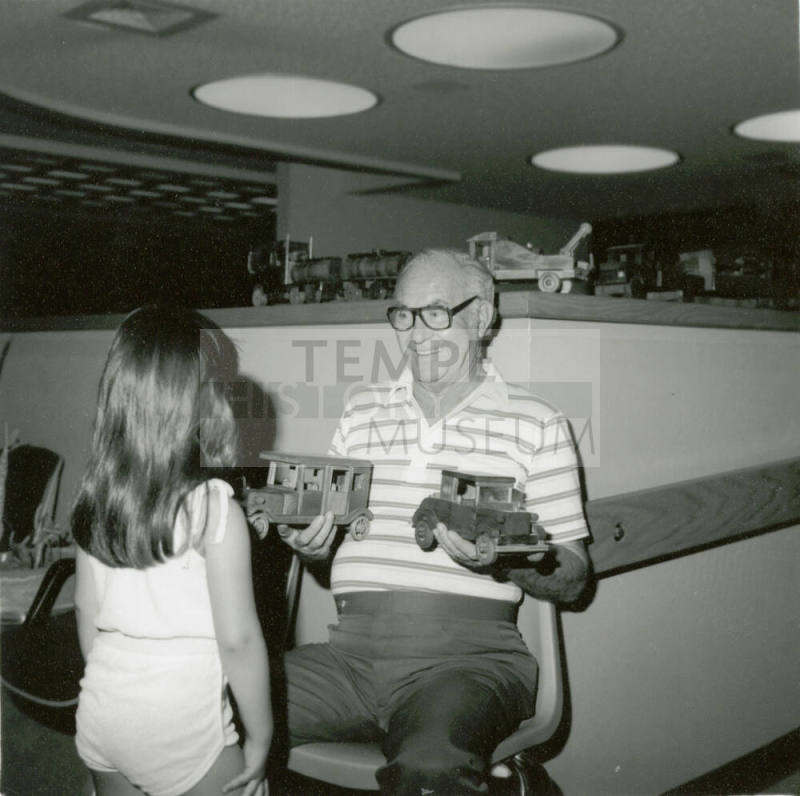Unidentified Man & Young Girl with Wooden Toys