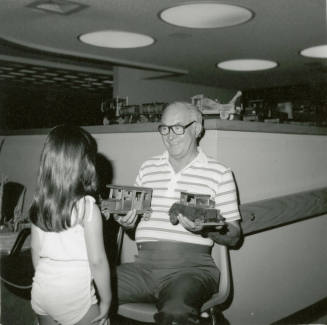 Unidentified Man & Young Girl with Wooden Toys