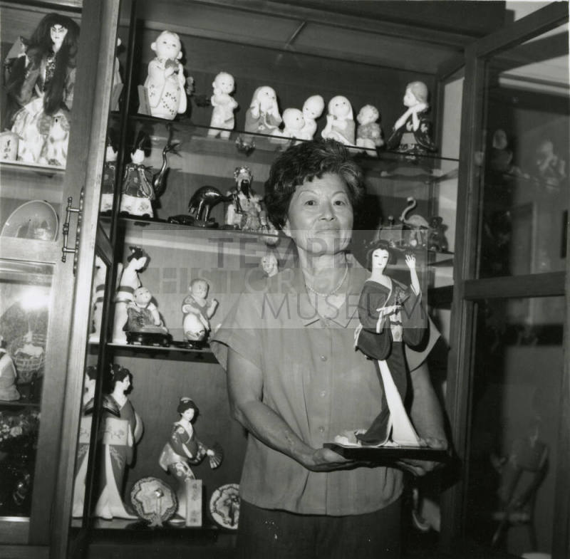 Unidentified Woman Holds Oriental Statuette - (1 of 2)