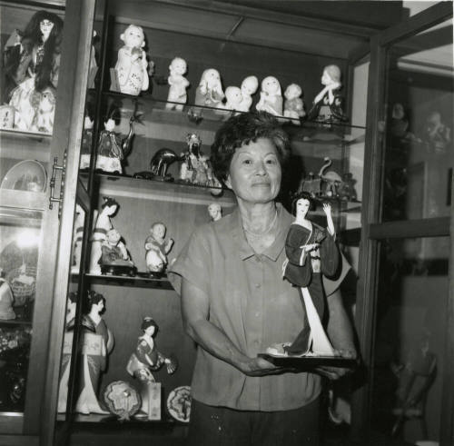 Unidentified Woman Holds Oriental Statuette - (1 of 2)