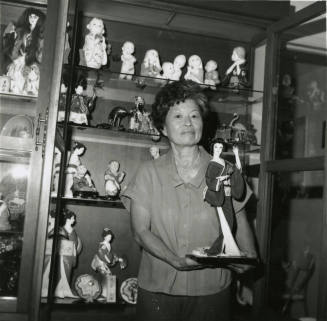 Unidentified Woman Holds Oriental Statuette - (1 of 2)