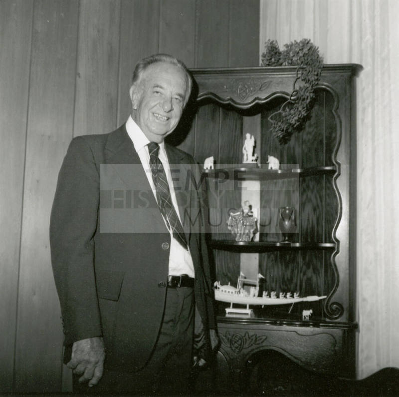 Unidentified Man In Front of Figurine Display Case