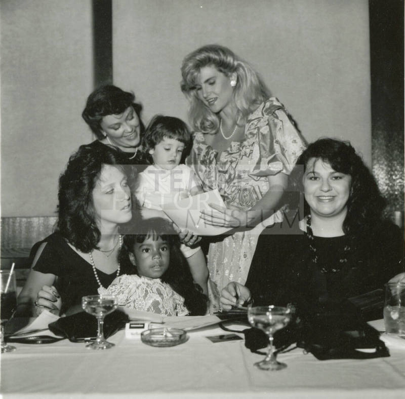 Group of women and young girls at a dinner table