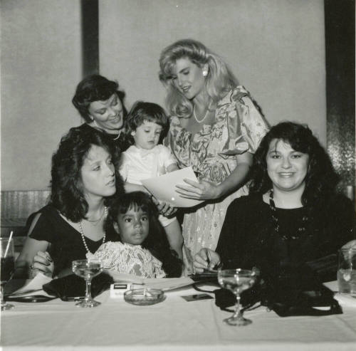 Group of women and young girls at a dinner table