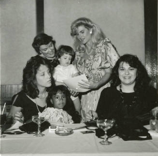 Group of women and young girls at a dinner table
