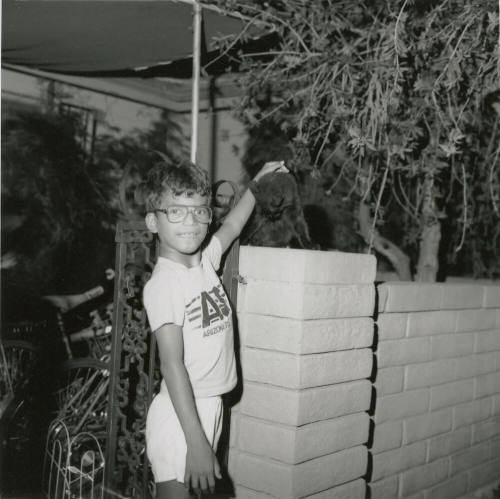 Unidentified Boy Pets Unidentified Black Cat