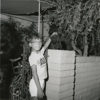 Unidentified Boy Pets Unidentified Black Cat