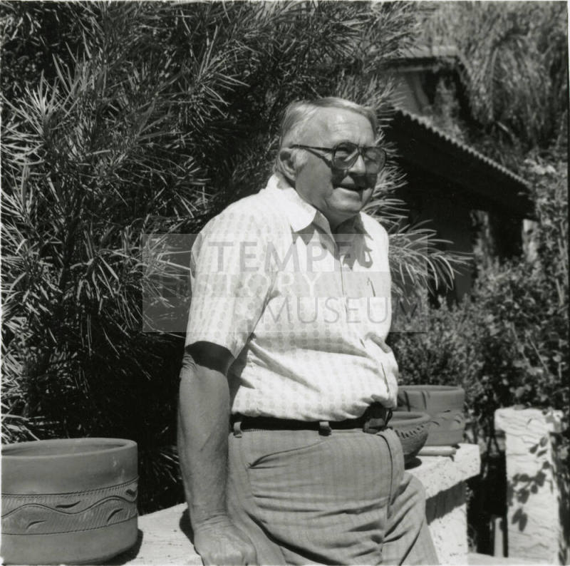 Unidentified Gray Haired Man Leaning On Fence