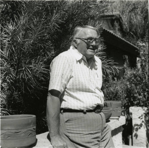Unidentified Gray Haired Man Leaning On Fence